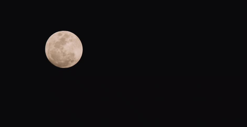 Glowing full moon contrasts with black night sky