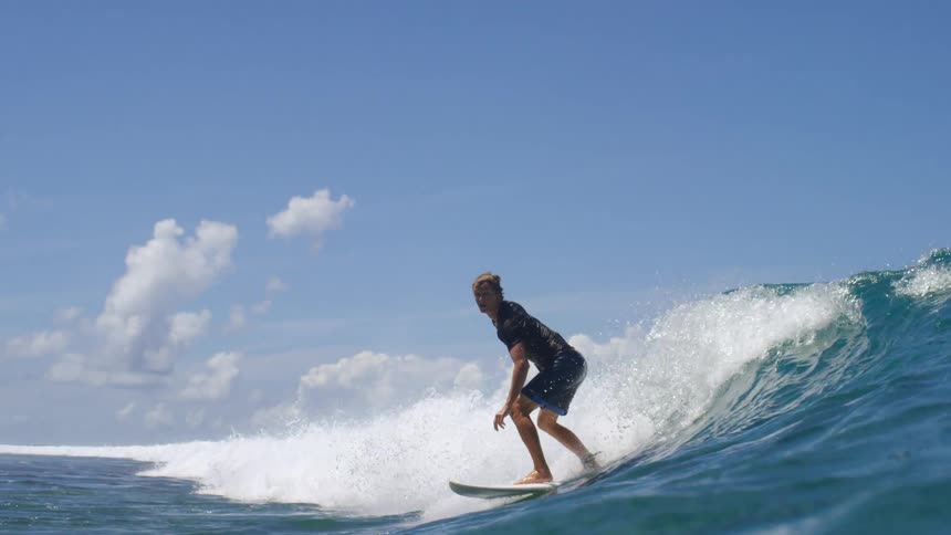 A man is surfing on waves in the ocean