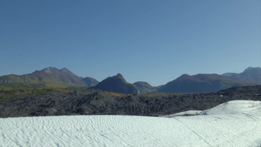 An aerial view of hills with snow on them