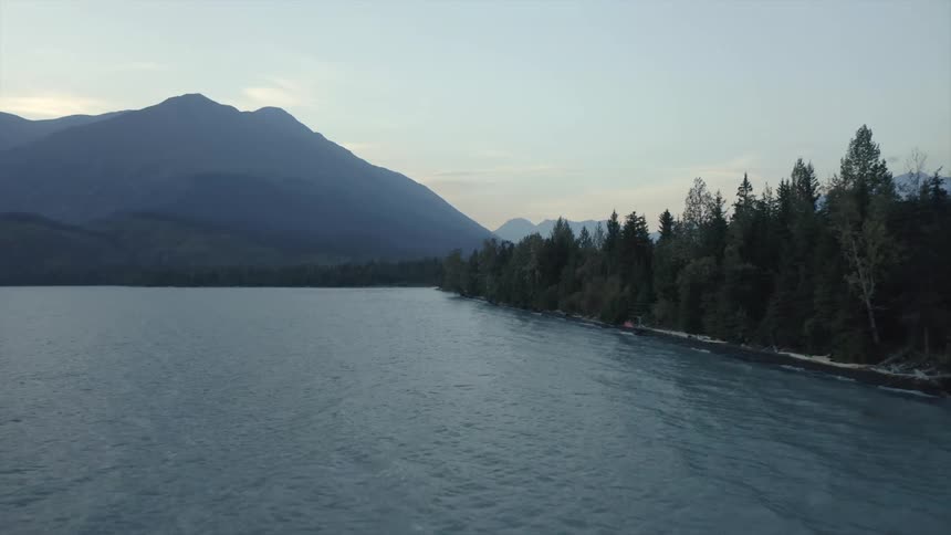 Aerial view of a body of water near mountains is displayed