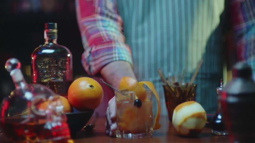A man is serving drinks at a night bar