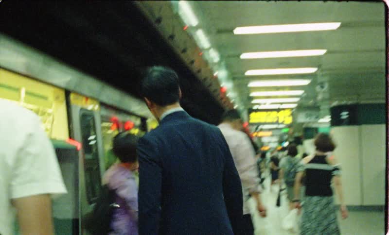 Man in suit gets on subway