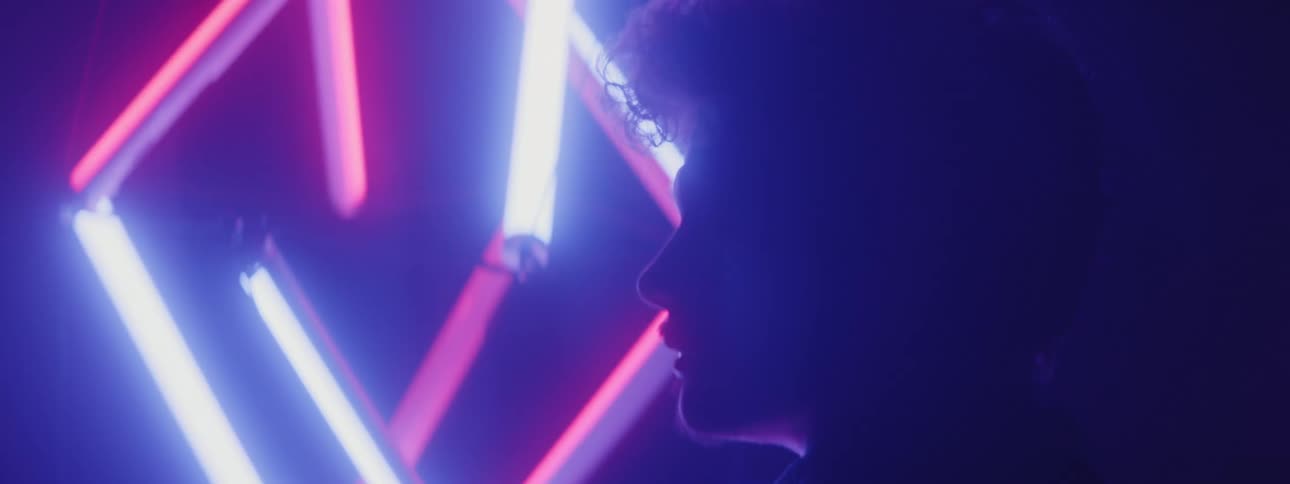 Neon light sculpture silhouettes persons head