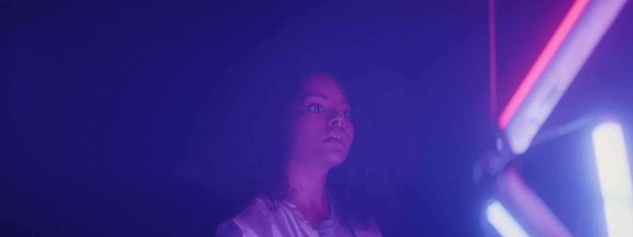 A woman looking at lights in a room