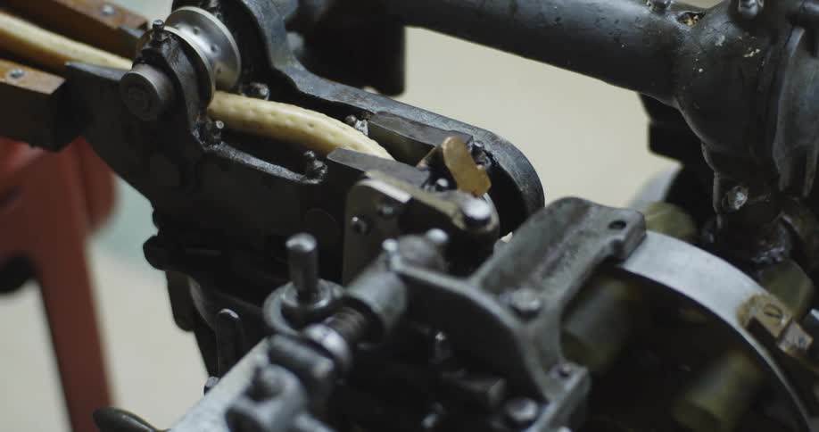 Machine imprints small dots onto long tubular shape