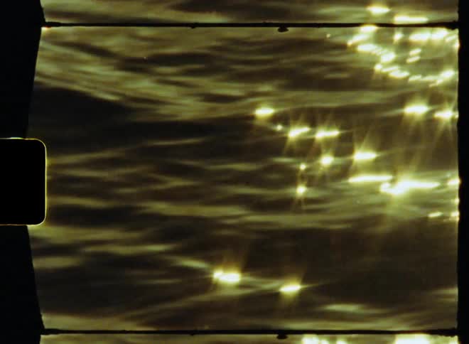 Footage of lake water is displayed during the sunset