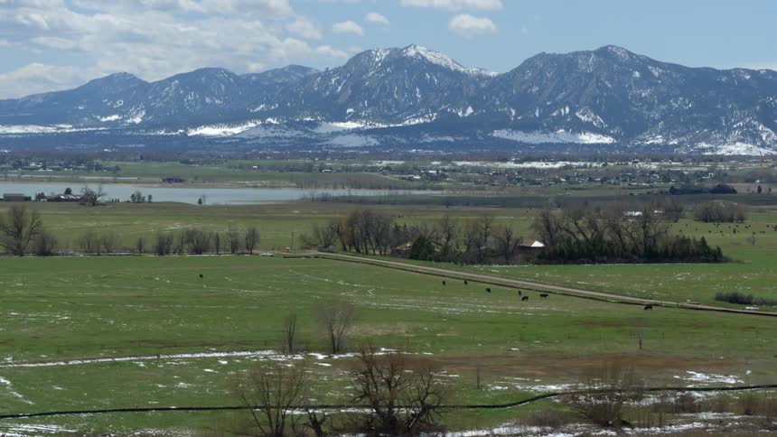 Landscape view of mountains and grassy fields is displayed