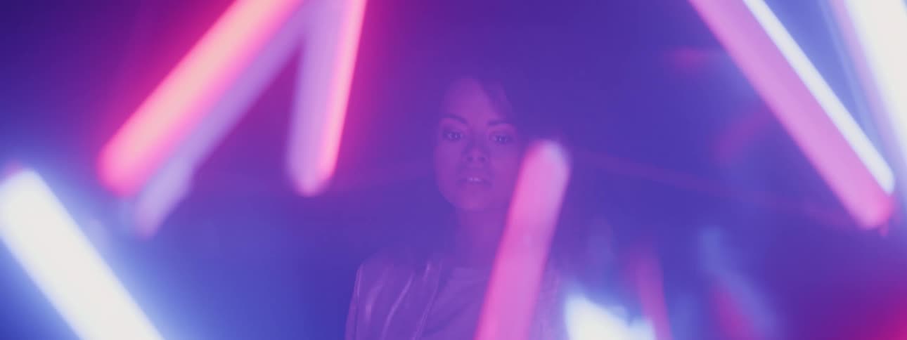 A woman is walking around a night life area