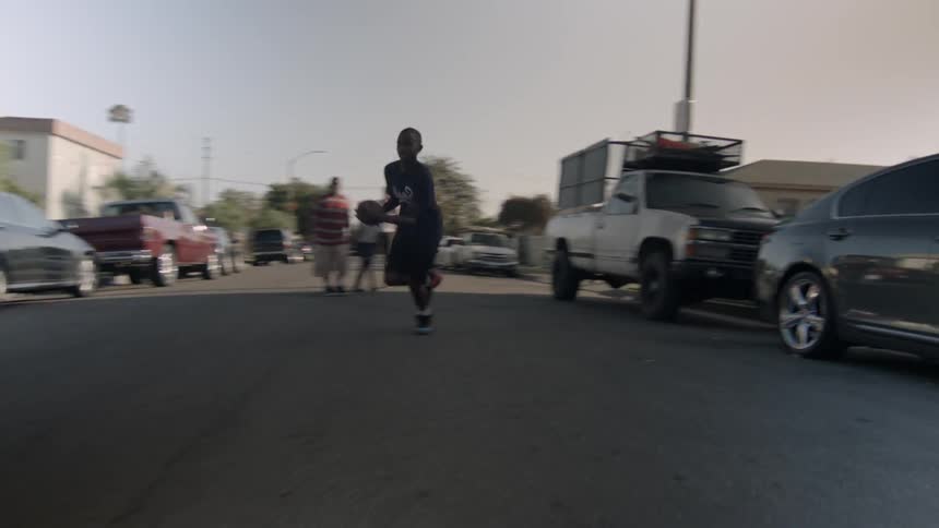 Children play football in the middle of a street