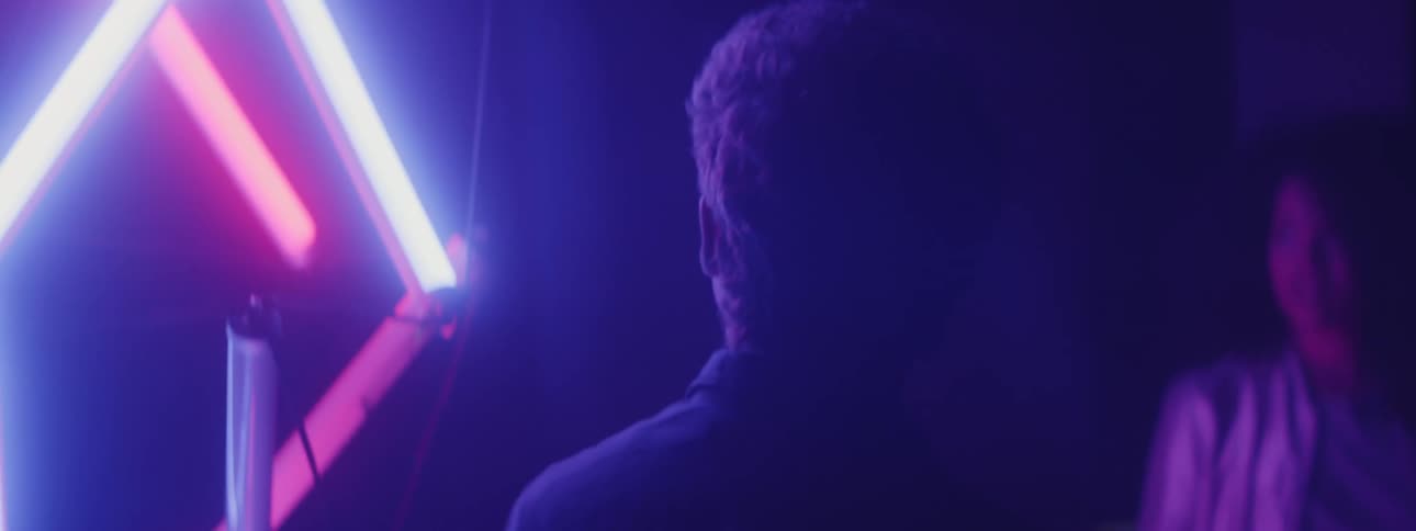 A man looks at the neon lights in a nightclub
