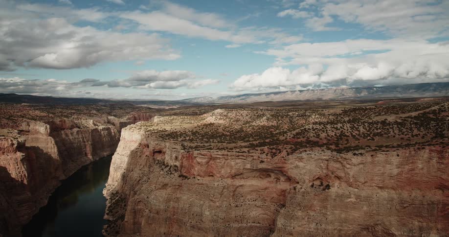 Clouds pass over a large canyon area