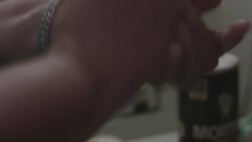 Woman patting and molding dough in between her hands