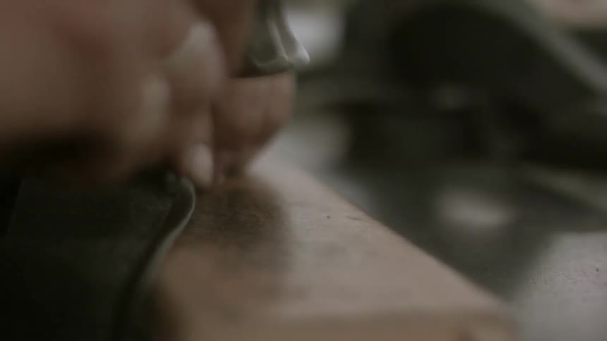 A person hammering something flat