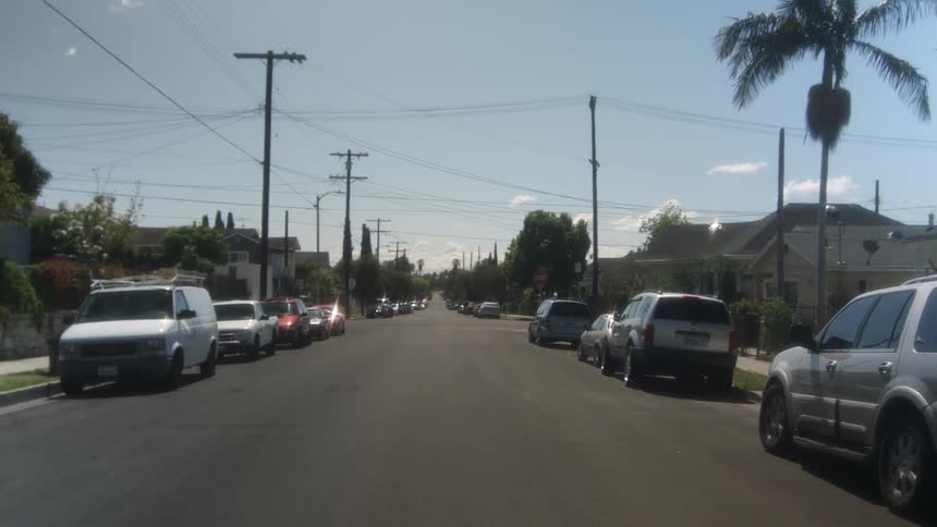 A car lined street during the day