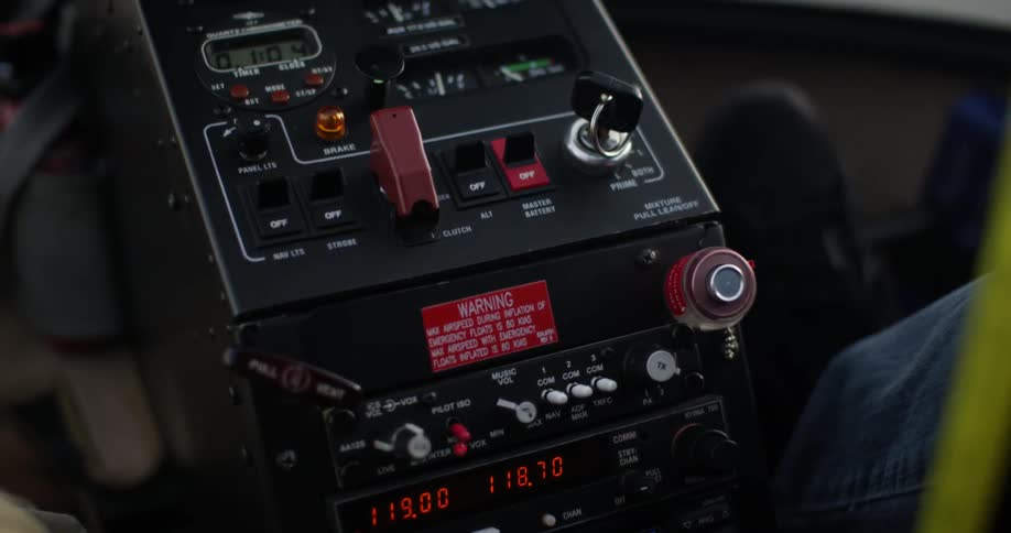 Person using controls and switches inside helicopter