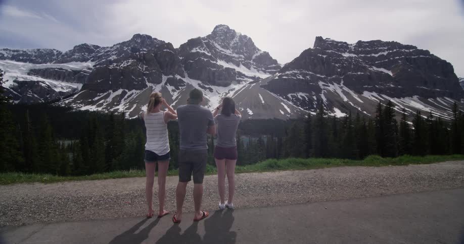 Three women look out over a mountain range