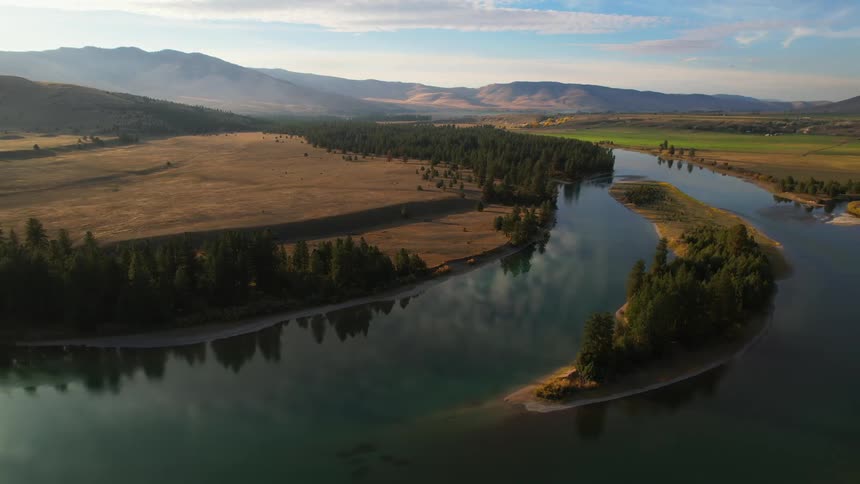 An aerial view of a river near some hills