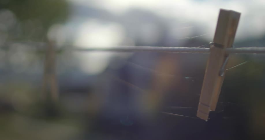 Clothespins are hanging on a line outside