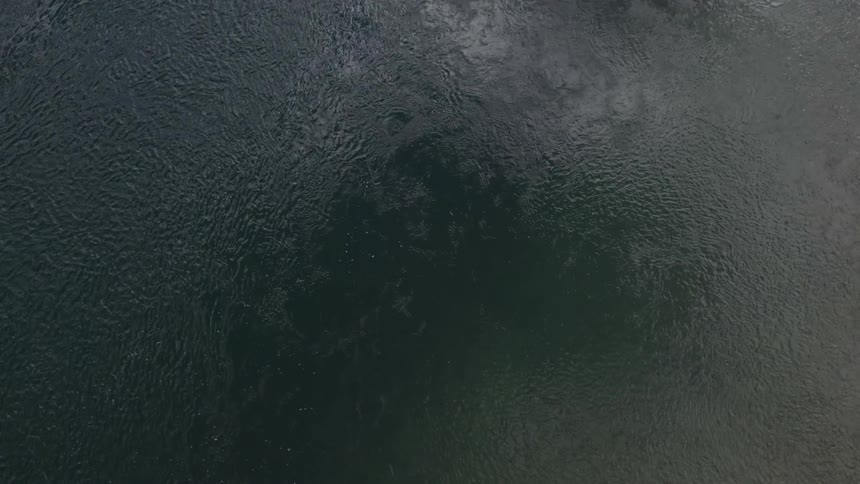 Aerial view of a large body of water as it ripples and waves