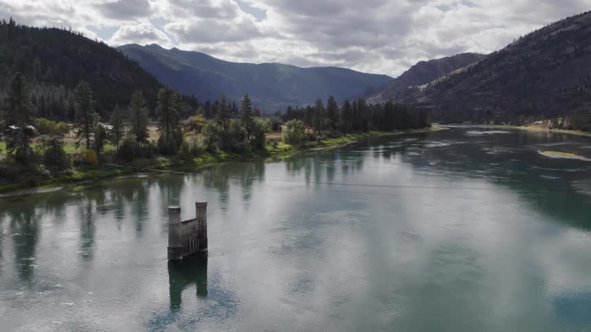 Aerial view of a body of water near mountains in spring