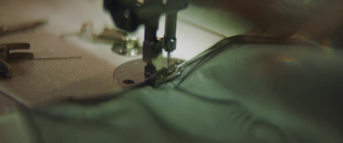 A person is sewing fabric with a sewing machine