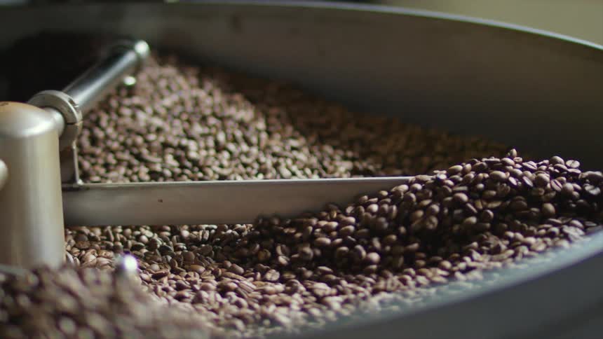 Coffee beans roasting on a spinning machine