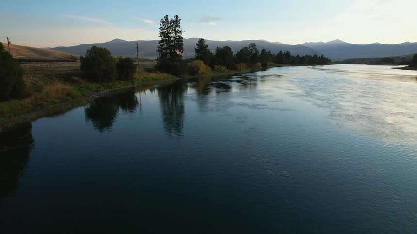 The river is reflecting the light near the mountains