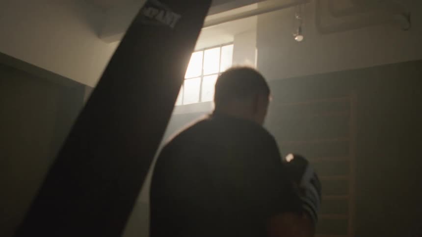 A man is jumping around punching the heavy bag