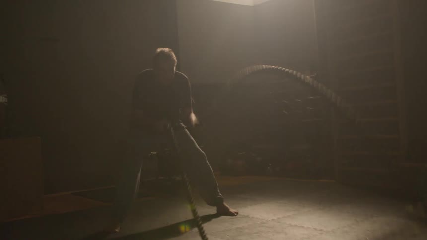 A man is working out using equipment indoors