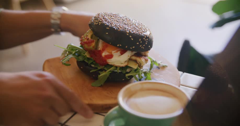 A man sets a fancy sandwich down on the counter