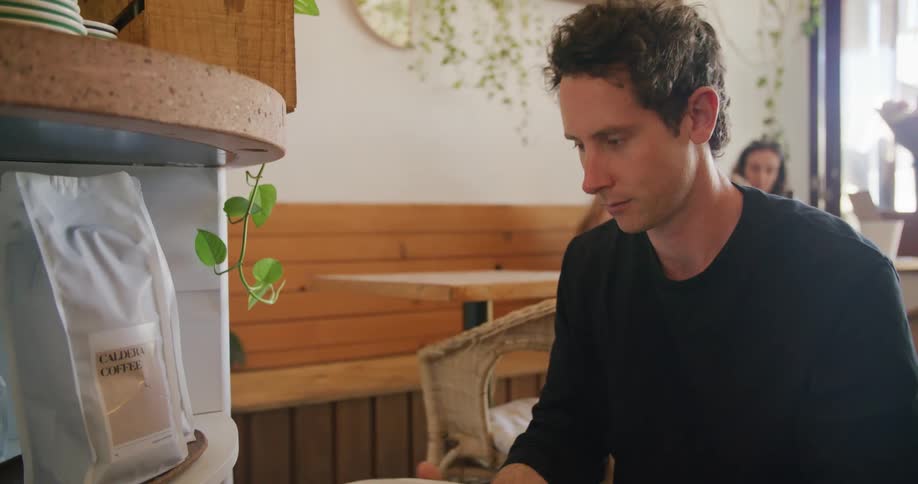 A man is stacking the shelves in the restaurant