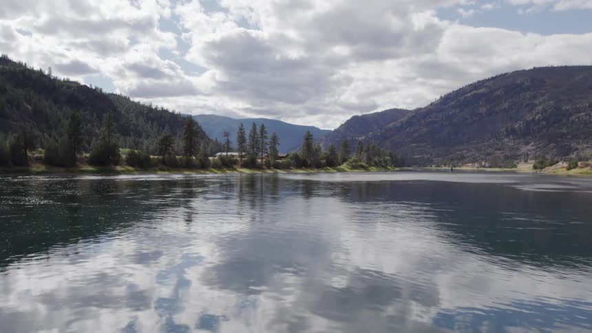 A landscape view of a lake in front of hills