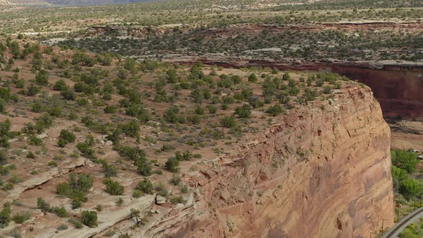 Highway skims cliff topped by scrub covered plateau