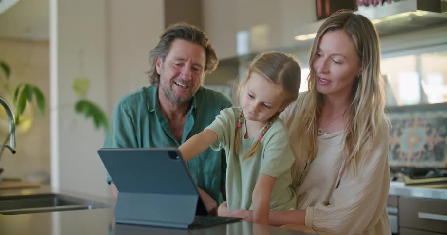 Family using a tablet over the kitchen countertop at home