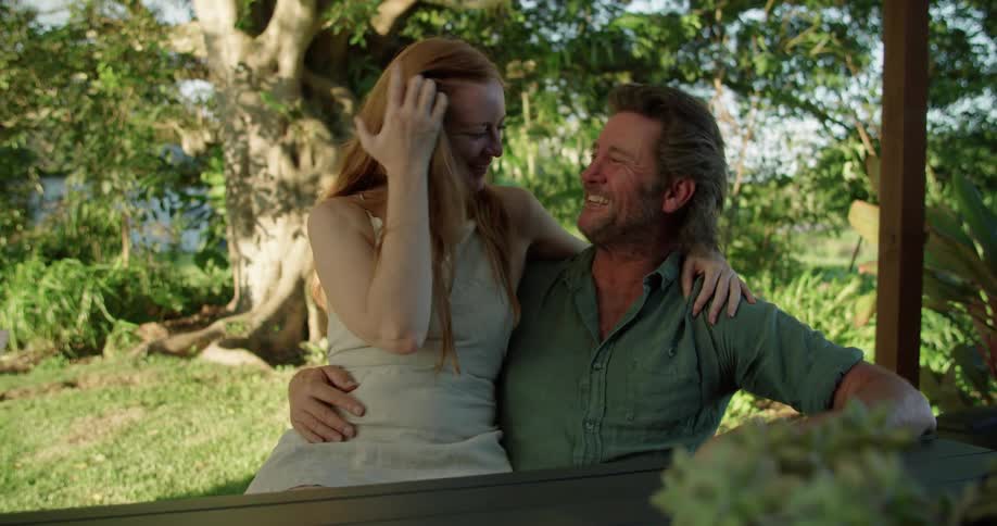 Husband and wife are sitting outdoors together in spring