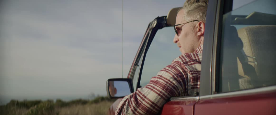 A man sitting in a car outdoors