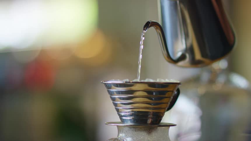 Water is being poured into a coffee pot