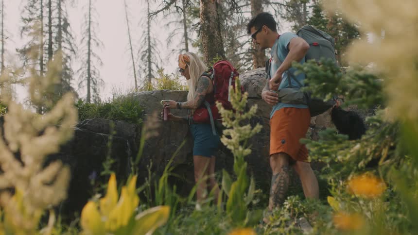 A man and woman hike together outside