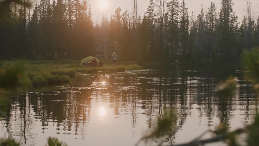 A view of people camping out near a lake