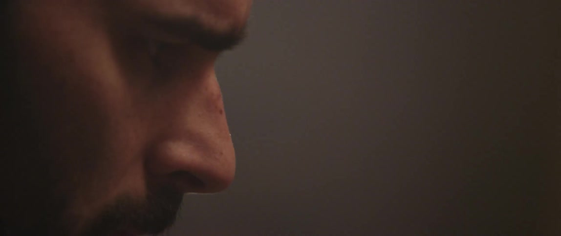 A man furrows his brow in concentration