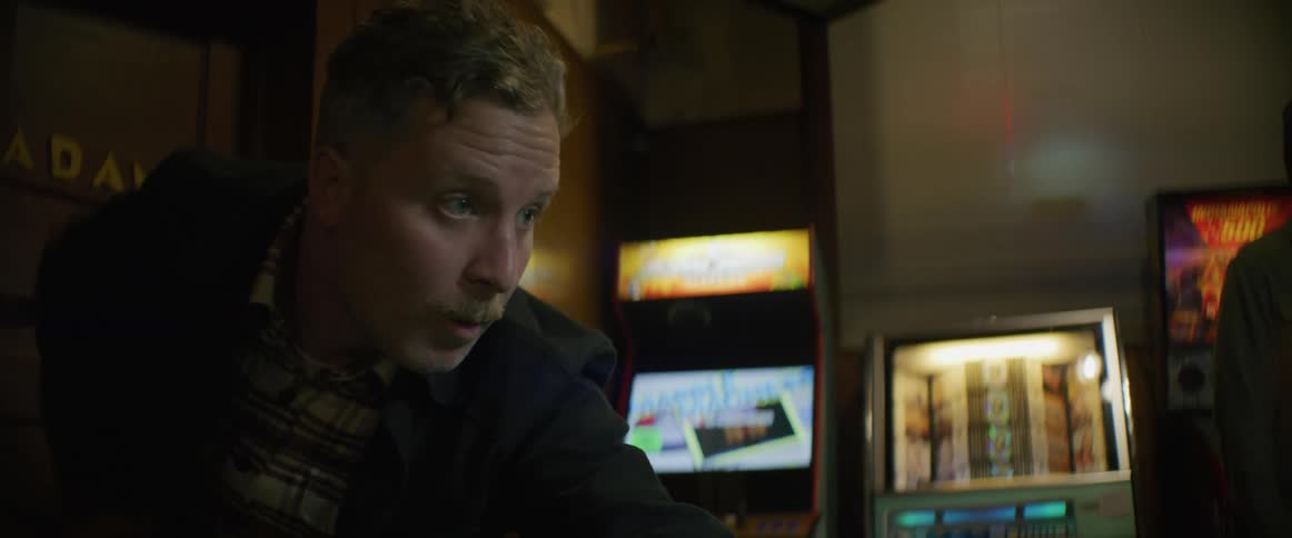 A man is playing a game of pool indoors