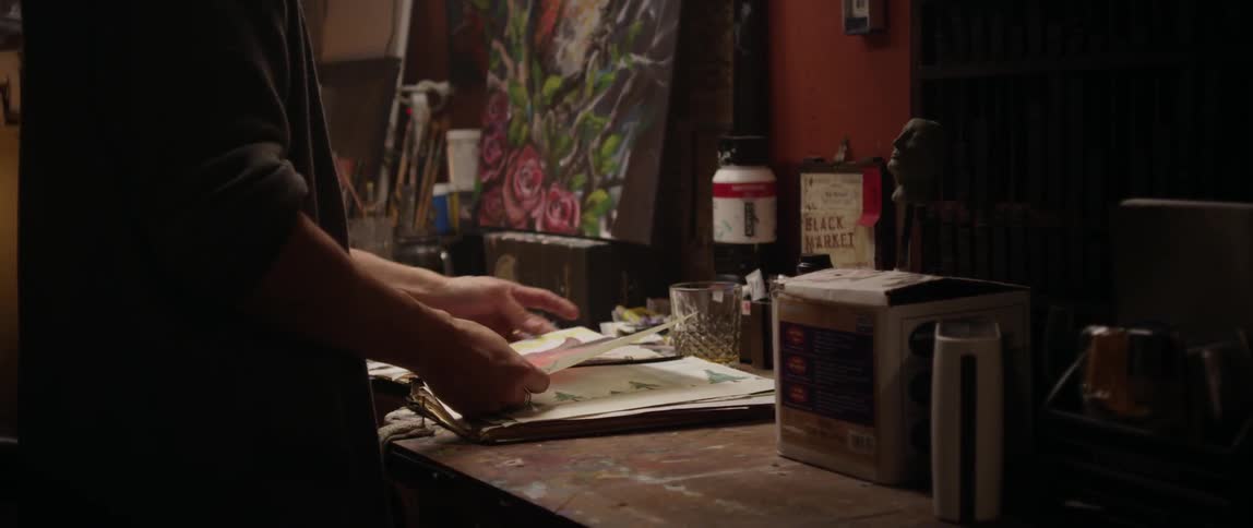 A person sorts drawings