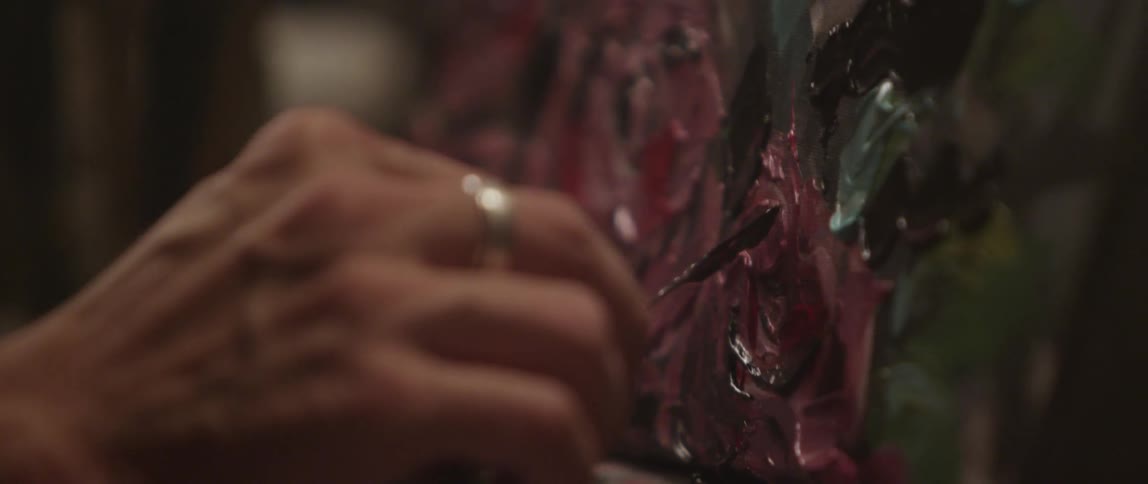 A person is painting on a canvas