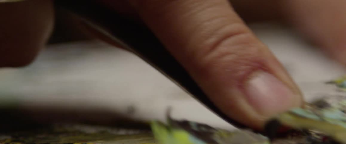 A tool is being used to scrape up paint