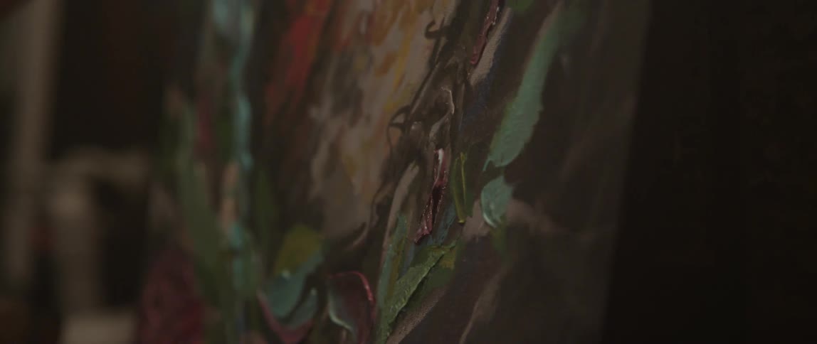 Person painting a bird with oils on canvas