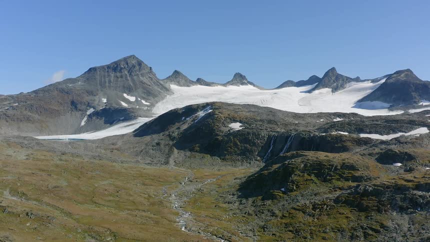 Aerial view of snow covering the summit of a mountain range