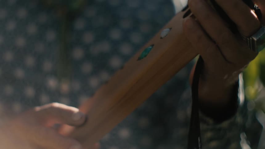 A man moves his instrument away from his mouth as he finishes playing