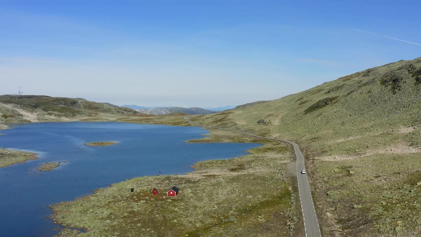 An aerial view of a lake near a mountain