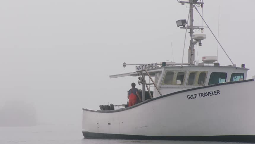A man is on a boat in a body of water