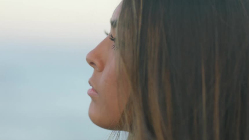 A woman smiles as she poses
